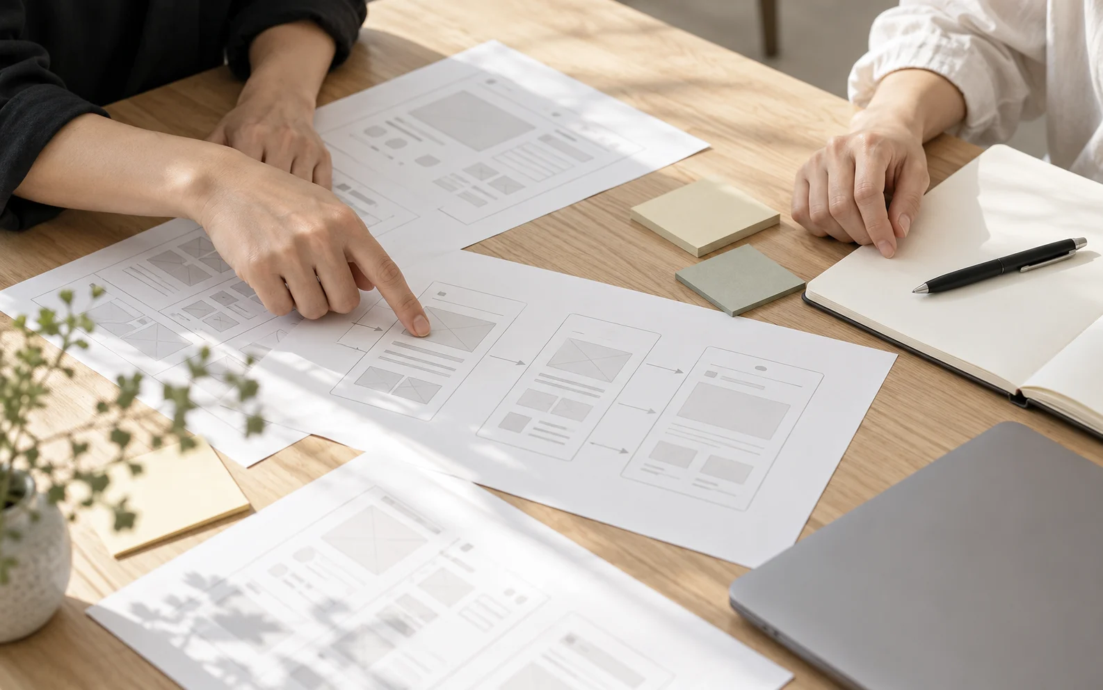 A team discussing product wireframes around a table